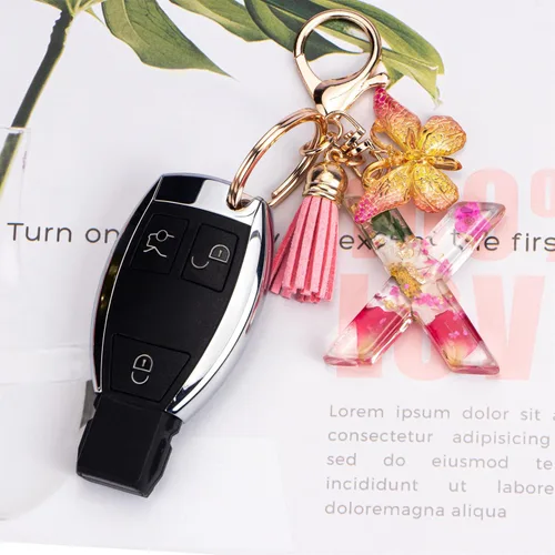 Vista 3 de Lindos llaveros para mujeres y niñas, llaveros de letra inicial con borla de mariposa, dije para bolso, mochilas, bolsos de mano