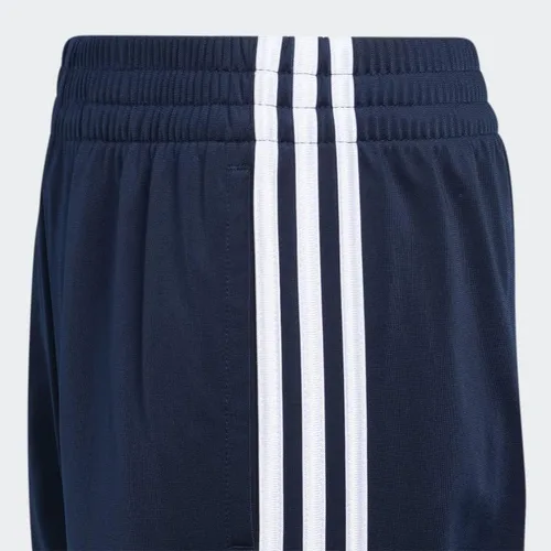 Vista 3 de adidas Pantalones deportivos icónicos de tricot para niños de talla grande, Azul marino colegial