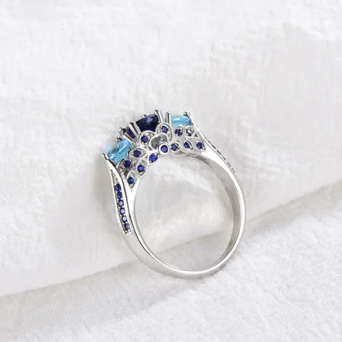 Vista 4 de Creative Fashion - Anillo de plata 925 brillante con tres piedras y zafiro con piedra natal de aguamarina azul, anillo de compromiso de eternidad