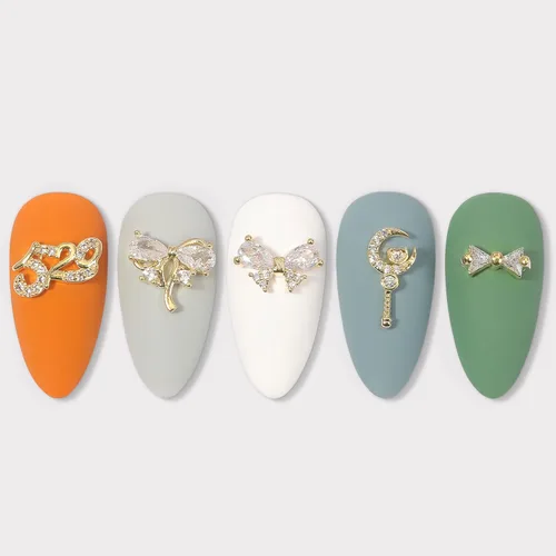 Vista 4 de Dijes y gemas para uñas, circonita de cobre dorado, múltiples formas 3D, diamantes de imitación de metal de lujo para uñas, 14 piezas 13 dijes