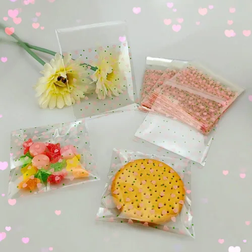 Vista 5 de 100 bolsas de celofán transparente con corazón rosa de San Valentín para suministros de panadería