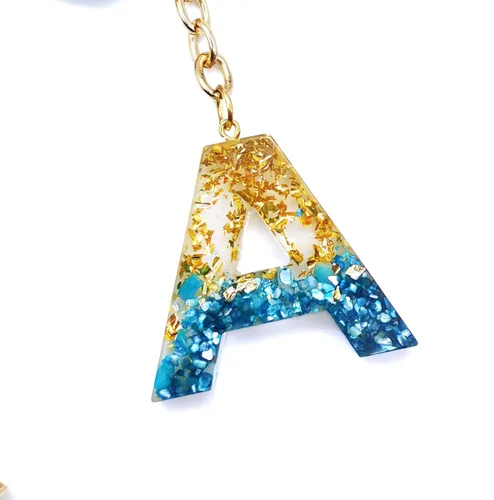 Vista 2 de Llavero con letra inicial del alfabeto azul, dije dorado con purpurina dorada, llavero con borla para bolso, bolsos, mujeres y niñas
