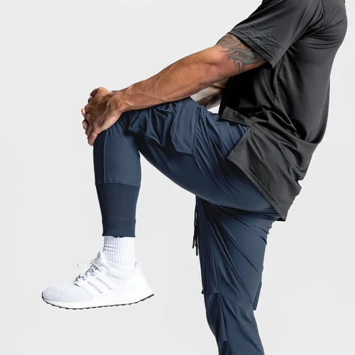 Vista 6 de Pantalones de entrenamiento ligeros para hombre con bolsillos con cremallera