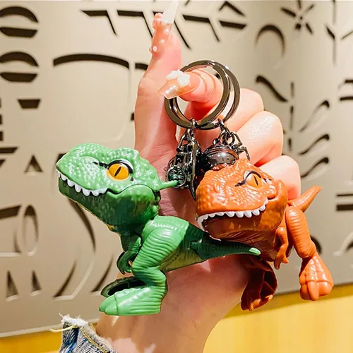Vista 3 de Chngna Lindo llavero de dinosaurio, bonitos regalos de dinosaurio, llavero de mochila con campana pequeña, llaveros de automóvil de dinosaurio