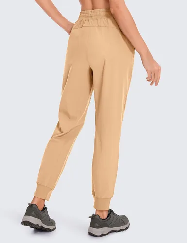 Vista 4 de CRZ YOGA Pantalones deportivos para mujer, impermeables, para exteriores, golf, atléticos, ligeros, con bolsillos con cremallera, de 27 pulgadas