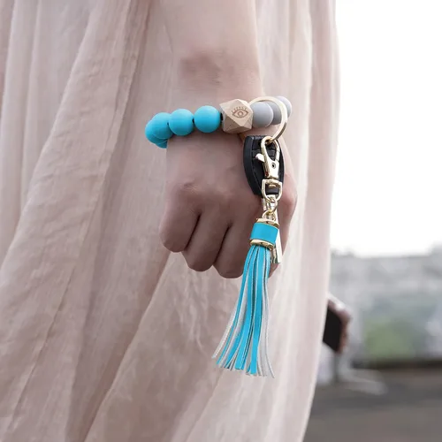 Vista 3 de Llavero de silicona para mujer con cuentas de llavero de pulsera portátil de borla de coche