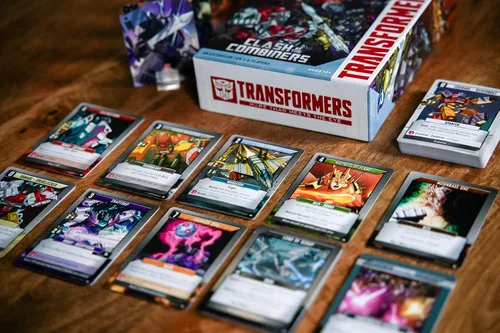 Vista 7 de Renegade Game Studios Transformers Deck Building Juego Choque de la Expansion for 1-5 Players Featuring 6 Giant-Sized Cards and 75 New Strategy