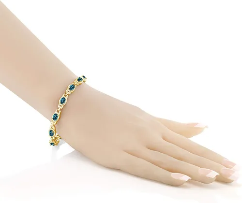 Vista 2 de Gem Stone King Pulsera de tenis ovalada de plata chapada en oro amarillo de 18 quilates con topacio azul Londres para mujer