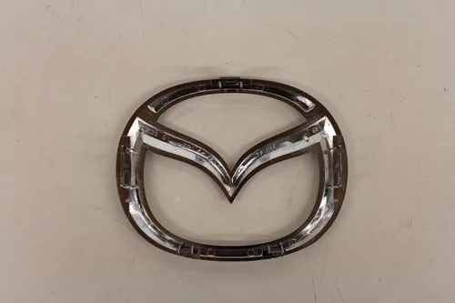 Vista 2 de Partes Originales de Mazda C235-51-731A Emblema de Logotipo Frontal