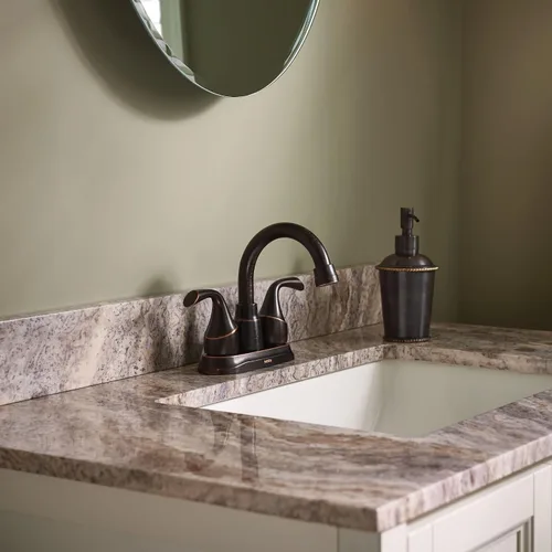 Vista 7 de Grifo de lavabo de baño Moen Idora de bronce mediterráneo con dos manijas de montaje central con conjunto de desagüe, 84115BRB