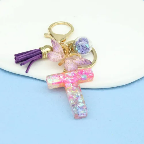 Vista 2 de Llaveros con letras iniciales para mujeres y niñas, mochila con resinas, letras del alfabeto, llaveros de coche, bola de mariposa, borla con dije