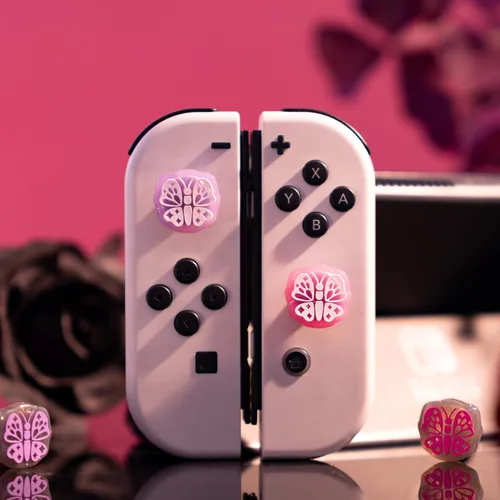 Vista 6 de GeekShare Bonitas tapas de silicona para el pulgar, funda de joystick compatible con Nintendo SwitchOLEDSwitch Lite, 4 unidades, mariposa