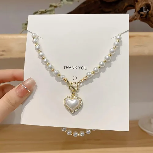 Vista 2 de GELMOINY Collares de perlas para mujer, collar de perlas de imitación de 0.23 pulgadas, collar de perlas de corazón chapado en oro de 14 quilates