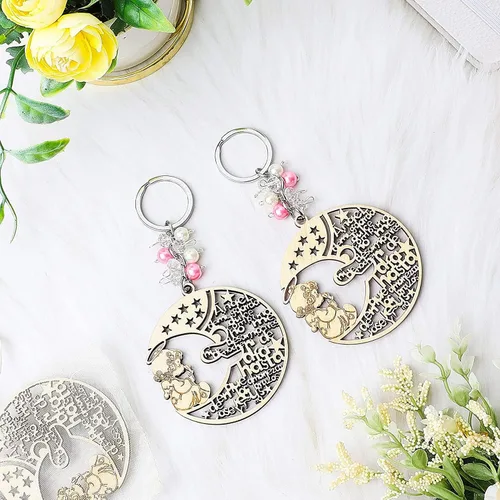 Vista 8 de YRP 12 piezas de bautismo rosa niña madera ángel luna diseño llavero bautismo favores con ángeles para niño y niña recuerdos de bautizo con bolsas