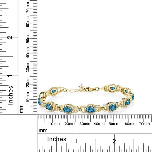 Vista 3 de Gem Stone King Pulsera de tenis ovalada de plata chapada en oro amarillo de 18 quilates con topacio azul Londres para mujer