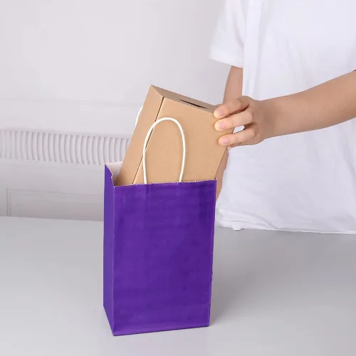 Vista 9 de Oikss Cada paquete de 100 bolsas pequeñas de papel kraft morado y amarillo con asas a granel