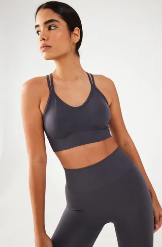Vista 4 de COMEUP Sujetador deportivo sin costuras con tiras para mujer, almohadillas extraíbles en el pecho. Sujetador deportivo de soporte medio