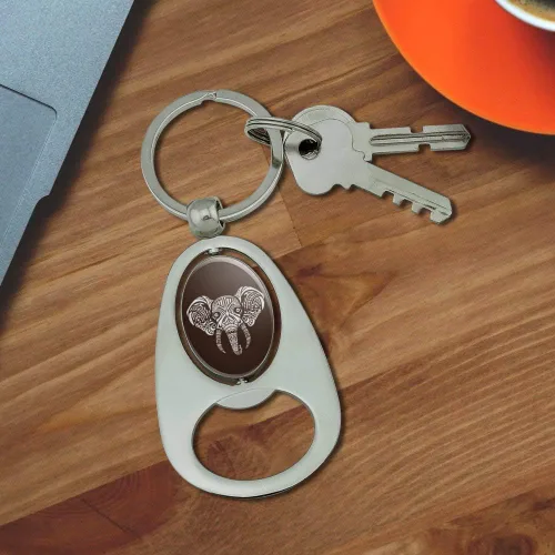 Vista 3 de GRAPHICS & MORE White African Elephant Tribal Keychain Chrome Metal Spinning Oval Bottle Opener