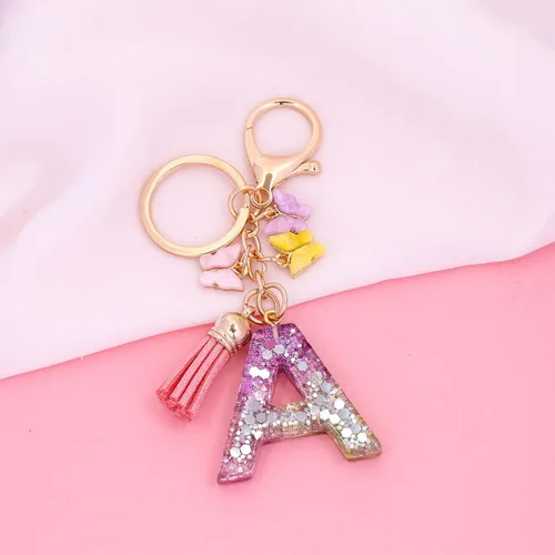 Vista 2 de Llavero de letra inicial del alfabeto de moda, colgante de borla de mariposa, llavero para bolso, bolsos de mano para mujeres y niñas