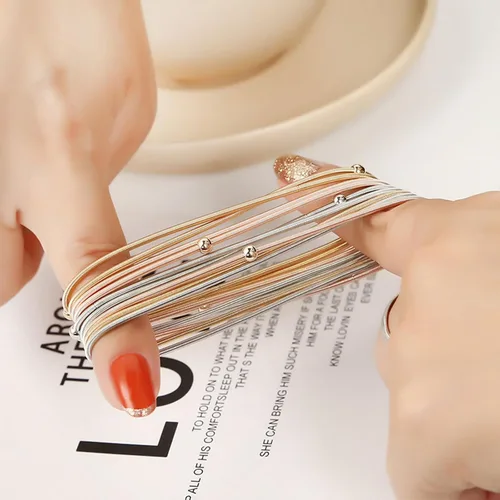 Vista 3 de YANCHUN 10 pulseras de cuerda de guitarra para mujer, pulseras de hilo en capas, pulseras elásticas plateadas, pulseras de oro, joyería