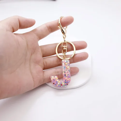 Vista 5 de Mlouye Llaveros coloridos con letras de estrella para mujeres y niñas, lindas resinas de la A a la Z, letras del alfabeto con borla para llaves