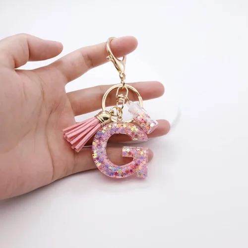 Vista 5 de Mlouye Llaveros coloridos con letras de estrella para mujeres y niñas, lindas resinas de la A a la Z, letras del alfabeto con borla para llaves