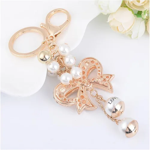 Vista 4 de Llaveros con lazo de cristal, llavero de perlas para automóvil, bolsos femeninos, accesorios colgantes (dorado)