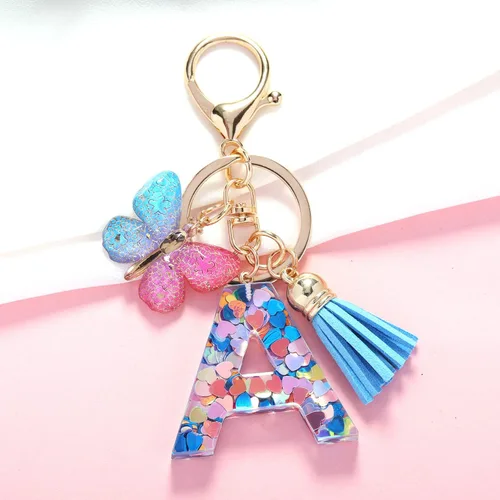Vista 2 de Llavero de letra inicial del alfabeto de moda, borla y mariposa, llavero para bolso, bolsos de mano para mujeres y niñas