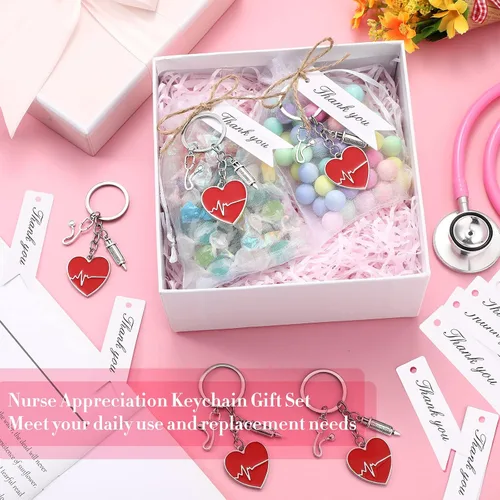 Vista 6 de Kigeli Juego de 16 llaveros para el día de la enfermera, regalos de graduación para estudiantes de enfermería con bolsas de organza