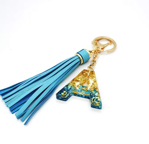 Vista 3 de Llavero con letra inicial del alfabeto azul, dije dorado con purpurina dorada, llavero con borla para bolso, bolsos, mujeres y niñas