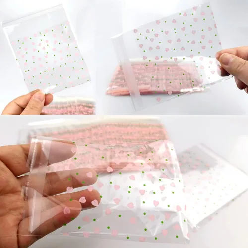 Vista 3 de 100 bolsas de celofán transparente con corazón rosa de San Valentín para suministros de panadería