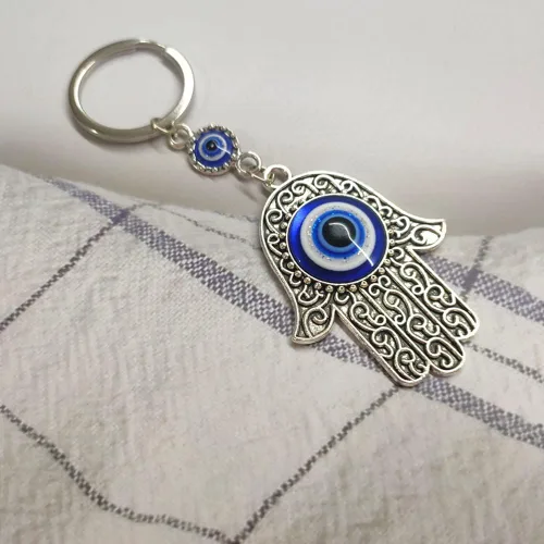 Vista 3 de UQUABESO Llavero Hamsa de cristal de ojo malvado, dije de diamantes de imitación, llavero de mano de Fátima para bolso, bolso, llavero de buena