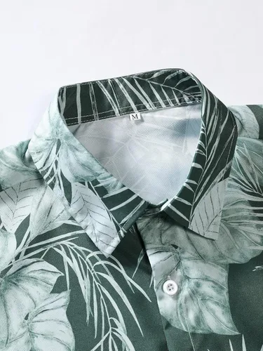 Vista 3 de OYOANGLE Camisa hawaiana de manga corta con botones y estampado tropical para hombre