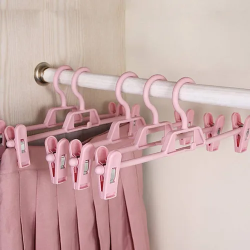 Vista 2 de DOITOOL Paquete de 10 perchas antideslizantes rosas para pantalones con clips ajustables, clips de plástico retráctiles para el hogar