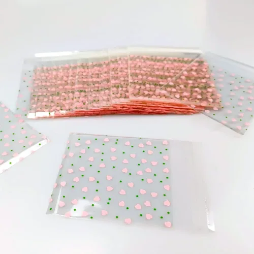 Vista 4 de 100 bolsas de celofán transparente con corazón rosa de San Valentín para suministros de panadería