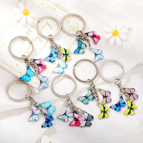 Vista 2 de GloryMM - Llavero con colgante de mariposa multicolor, llavero de mariposa, bonito dije para mujer, estilo A