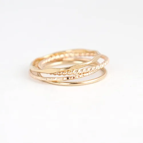 Vista 5 de 14k yellow gold filled stacking rings. minimalist metal stack bands set of four (4). various texture options - smooth, hammered, stardust, twist, or