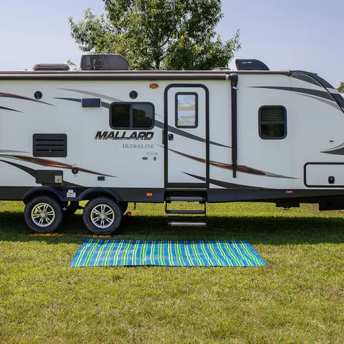Vista 2 de Camco Práctico tapete para cámper y caravana, cuenta con prácticos bolsillos y asas integradas para transportar, mide 72 x 108 pulgadas y se pliega