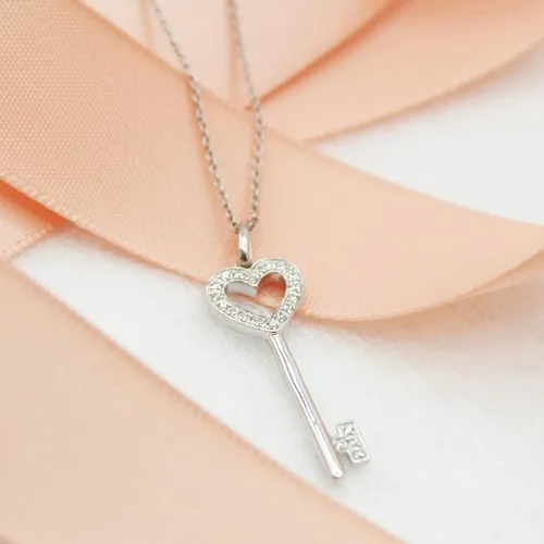 Vista 3 de Fifth and Fine Juego de collar con llave de corazón de diamante de 0.10 quilates en plata de ley. Cada pieza viene con una cadena de cable de plata