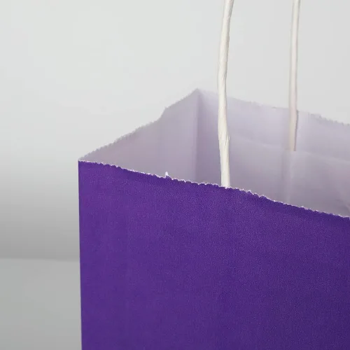 Vista 8 de Oikss Cada paquete de 100 bolsas pequeñas de papel kraft morado y amarillo con asas a granel