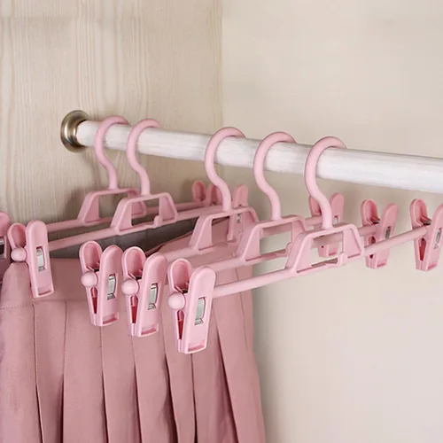 Vista 6 de DOITOOL Paquete de 10 perchas antideslizantes rosas para pantalones con clips ajustables, clips de plástico retráctiles para el hogar