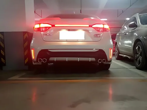 Vista 6 de iJDMTOY Luces reflectoras de parachoques LED de lente roja compatibles con Toyota Corolla Sedán 2019-22, funciona como faros antiniebla traseros