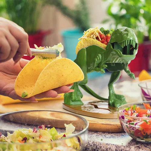 Vista 2 de Funwares Tacosaurus original - Soporte para tacos de dinosaurio, divertido y práctico regalo de elefante blanco, capacidad para 2 tacos