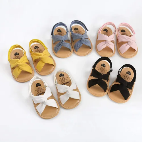 Vista 4 de GDSDYM Sandalias de verano para bebés y niñas con lazo de flores, suela suave, para vestido de boda, zapatos planos para recién nacidos, primeros