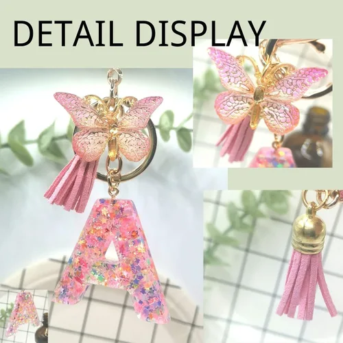 Vista 3 de Meefisher Llavero de letra inicial de mariposa con borla rosa púrpura y estrella, para cartera, monederos, mochila, bolsos, alfabeto, llavero