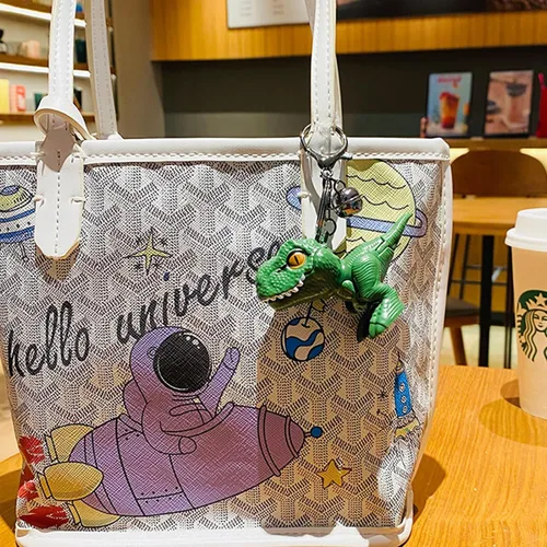 Vista 2 de Chngna Lindo llavero de dinosaurio, bonitos regalos de dinosaurio, llavero de mochila con campana pequeña, llaveros de automóvil de dinosaurio