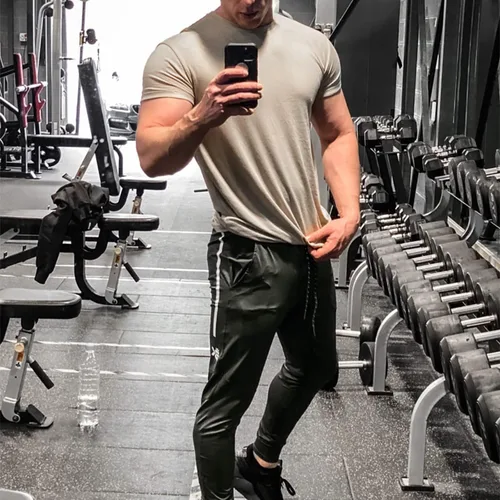 Vista 5 de BROKIG Pantalones deportivos ligeros de gimnasio para hombre, pantalones deportivos de entrenamiento con bolsillo con cremallera, pantalones