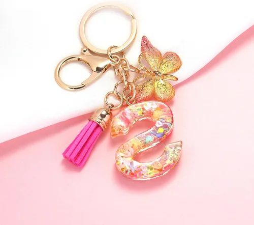 Vista 2 de OKAICEN Llavero con letra inicial del alfabeto de moda, llavero con colgante de mariposa y borla roja rosa para bolso de mano para mujeres y niñas