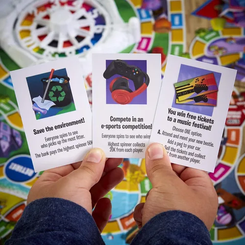 Vista 15 de Juego de mesa The Game of Life, juegos familiares para niños de 8 años en adelante, las clavijas vienen en 6 colores, juegos de mesa familiares