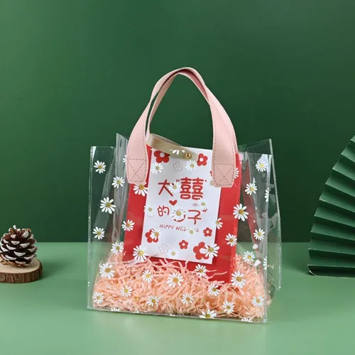 Vista 2 de YMASELA Bolsa de regalo transparente con asas (9.8 x 9.1 x 5.5 pulgadas, 2 unidades) bolsa de embalaje de regalo impermeable de plástico resistente